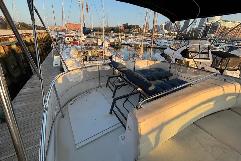 Moonstruck Yacht Photos Pics 1998 Carver 530 Voyager Pilothouse docked at marina, featuring spacious deck seating.