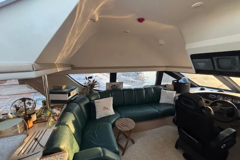 Moonstruck Yacht Photos Pics Luxurious interior of a 1998 Carver 530 Voyager Pilothouse with leather seating and helm.