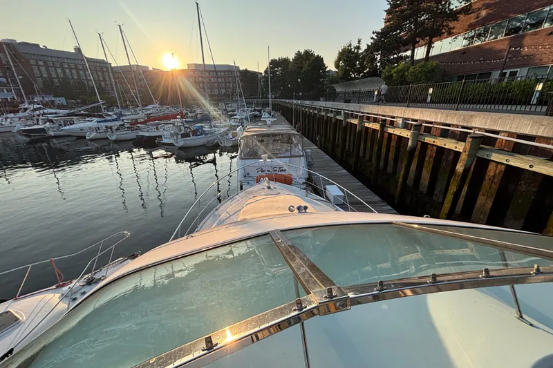 Moonstruck Yacht Photos Pics 1998 Carver 530 Voyager Pilothouse docked at sunset in a marina.
