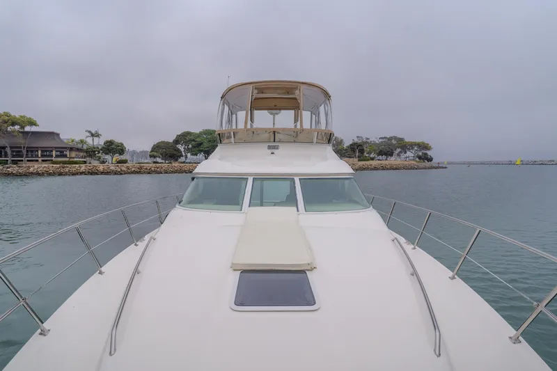 Waterfront Property Yacht Photos Pics 2000 Sea Ray 400 Sedan Bridge yacht on calm waters.