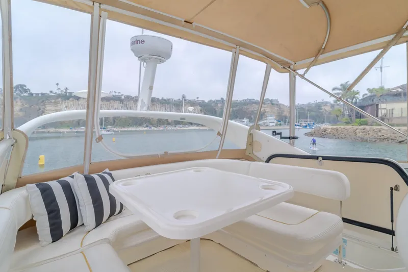 Waterfront Property Yacht Photos Pics Interior view of 2000 Sea Ray 400 Sedan Bridge yacht with seating and table.