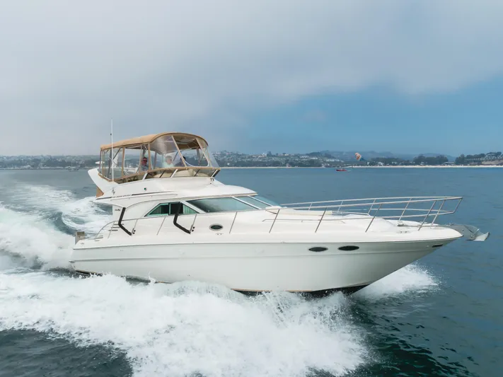 Waterfront Property Yacht Photos Pics 2000 Sea Ray 400 Sedan Bridge cruising on open water.