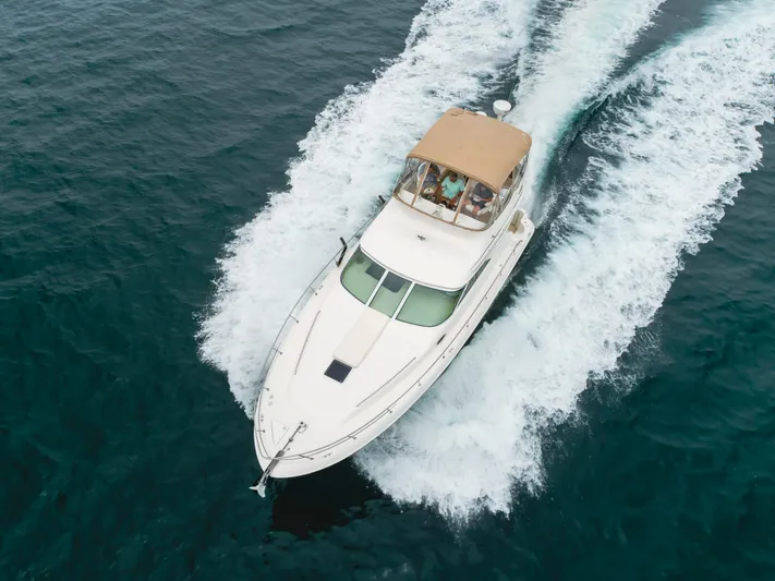 Waterfront Property Yacht Photos Pics 2000 Sea Ray 400 Sedan Bridge cruising on open water.