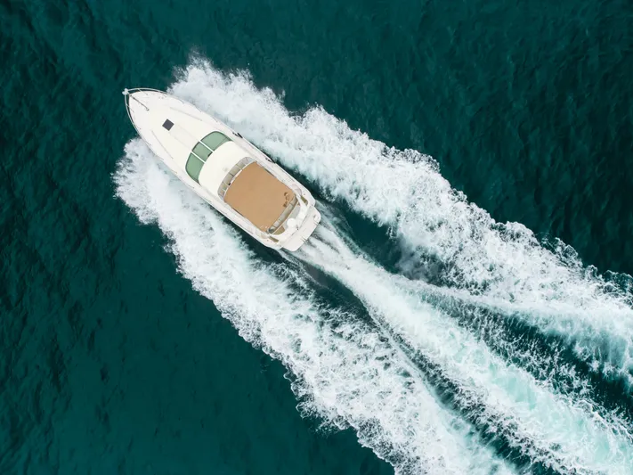 Waterfront Property Yacht Photos Pics Aerial view of 2000 Sea Ray 400 Sedan Bridge cruising on blue water.