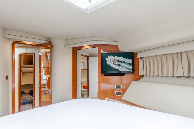 Waterfront Property Yacht Photos Pics Interior cabin of 2000 Sea Ray 400 Sedan Bridge yacht with TV and wooden accents.
