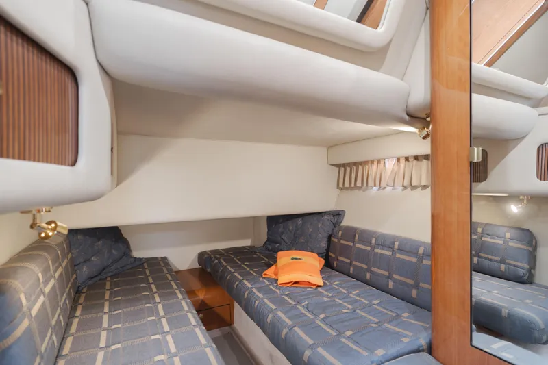 Waterfront Property Yacht Photos Pics Interior cabin of 2000 Sea Ray 400 Sedan Bridge with twin beds and blue upholstery.