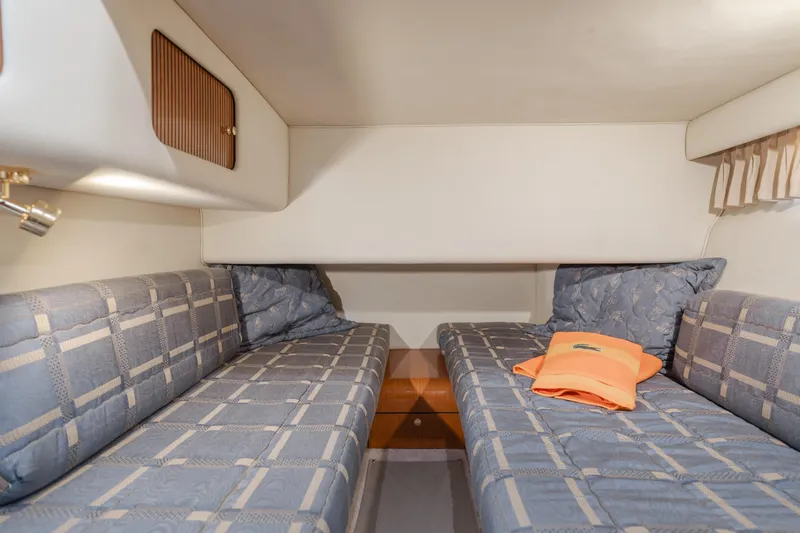 Waterfront Property Yacht Photos Pics Twin beds in the 2000 Sea Ray 400 Sedan Bridge cabin with blue checkered bedding.