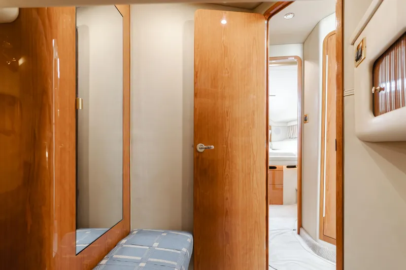 Waterfront Property Yacht Photos Pics Interior of 2000 Sea Ray 400 Sedan Bridge yacht with wooden doors and mirrored closet.