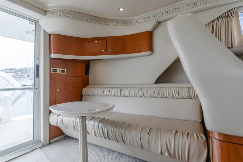 Waterfront Property Yacht Photos Pics Interior of 2000 Sea Ray 400 Sedan Bridge with leather seating and wooden cabinets.
