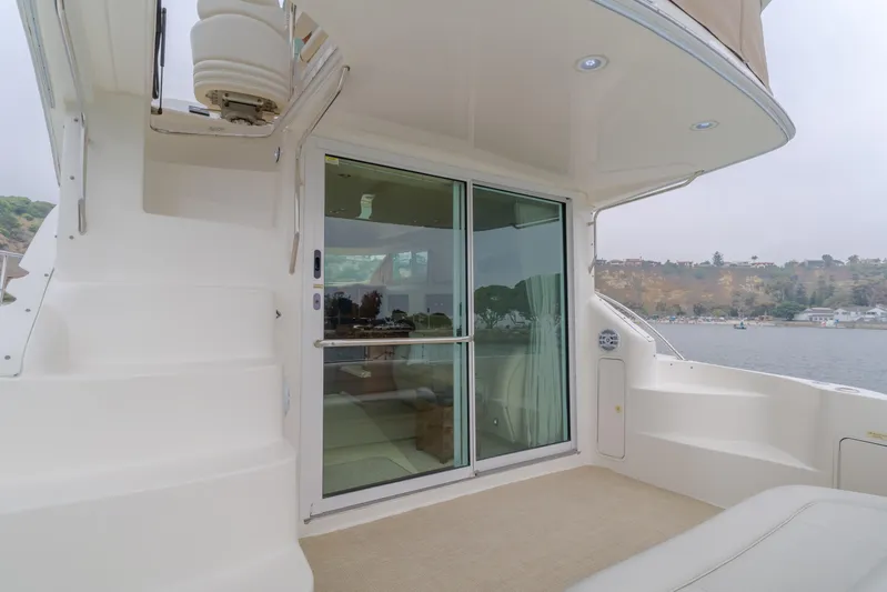Waterfront Property Yacht Photos Pics 2000 Sea Ray 400 Sedan Bridge yacht, rear deck with sliding glass doors and water view.