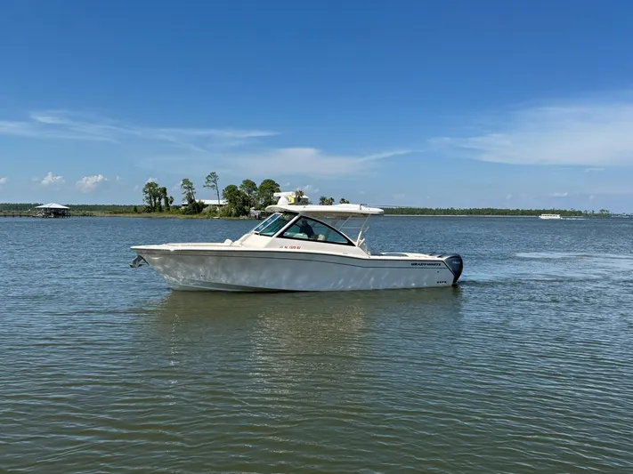  Yacht Photos Pics 2021 Grady-White Freedom 375 boat on calm water under clear blue sky.