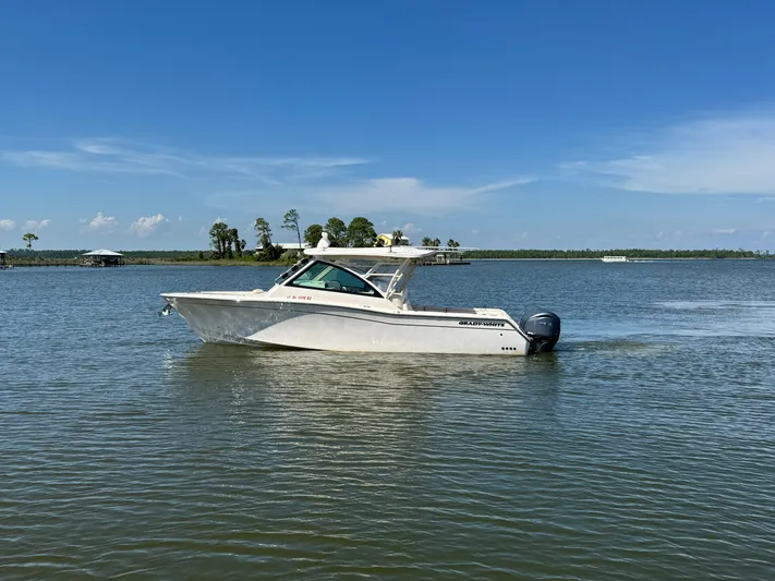  Yacht Photos Pics 2021 Grady-White Freedom 375 boat on calm water under clear blue sky.