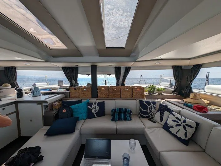  Yacht Photos Pics Luxurious interior of 2022 Fountaine Pajot Elba 45 catamaran with elegant seating and ocean view.