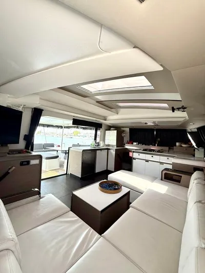  Yacht Photos Pics Luxurious interior of 2022 Fountaine Pajot Elba 45 catamaran with modern furnishings and ample natural light.