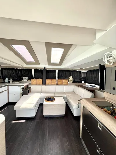  Yacht Photos Pics Luxurious interior of 2022 Fountaine Pajot Elba 45 catamaran with modern furnishings and skylights.