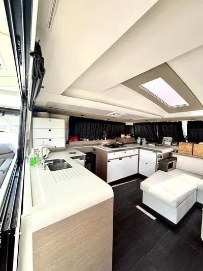  Yacht Photos Pics Modern kitchen interior of 2022 Fountaine Pajot Elba 45 catamaran, featuring sleek design and ample space.