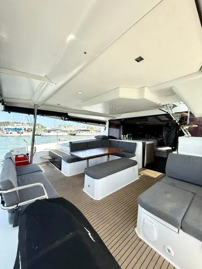  Yacht Photos Pics Spacious 2022 Fountaine Pajot Elba 45 yacht interior with modern seating and harbor view.