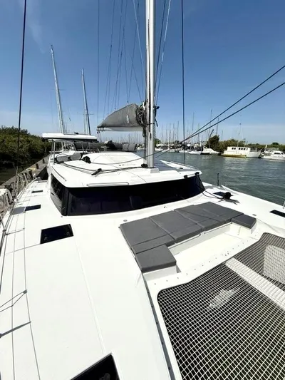  Yacht Photos Pics 2022 Fountaine Pajot Elba 45 catamaran docked, showcasing sleek design and spacious deck.