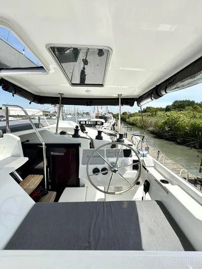  Yacht Photos Pics 2022 Fountaine Pajot Elba 45 catamaran cockpit with steering wheel and seating area.