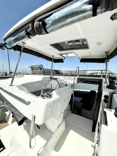  Yacht Photos Pics 2022 Fountaine Pajot Elba 45 yacht cockpit with steering wheel and canopy.