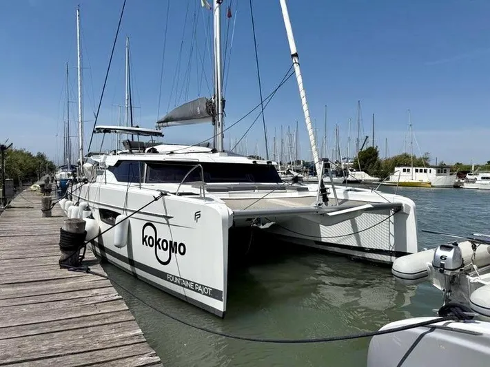  Yacht Photos Pics 2022 Fountaine Pajot Elba 45 catamaran docked at marina, clear sky background.