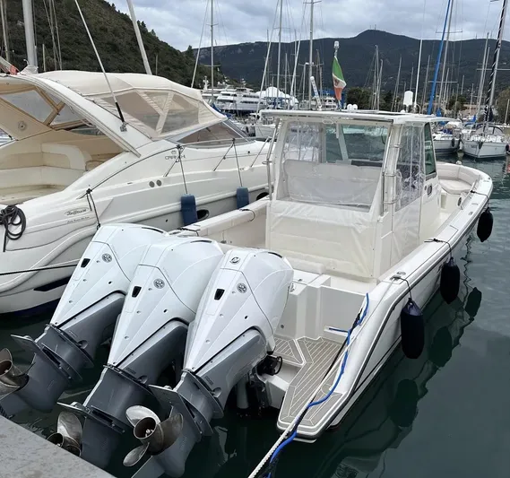  Yacht Photos Pics 2023 3B Craft 330 CC boat docked in marina with triple outboard engines.