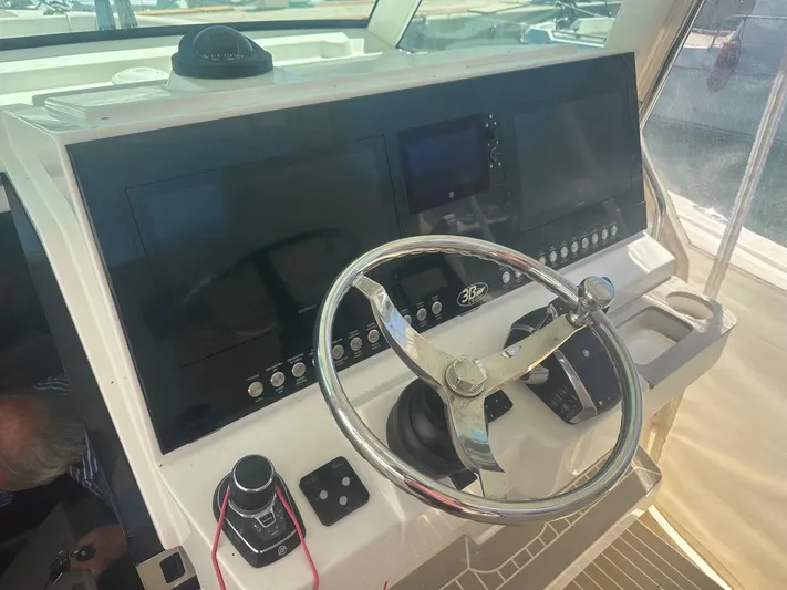  Yacht Photos Pics 2023 3B Craft 330 CC boat dashboard with steering wheel and navigation controls.