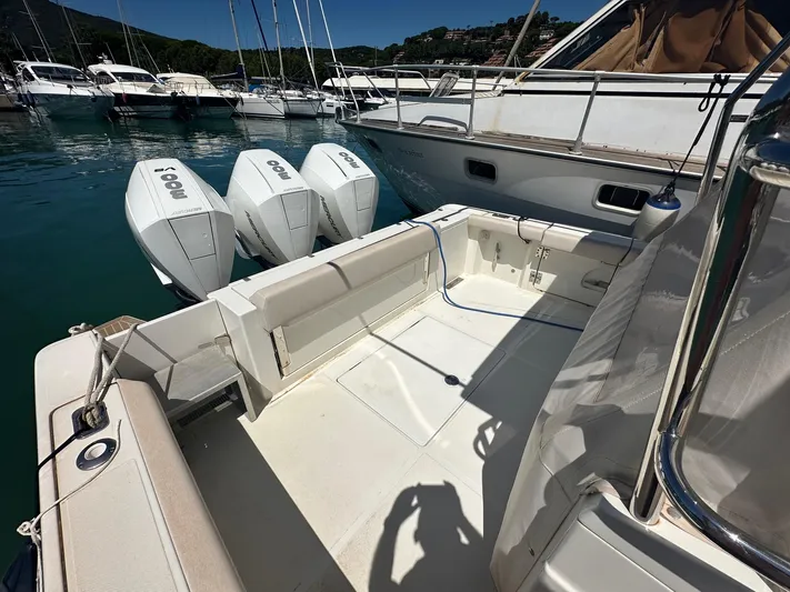  Yacht Photos Pics 2023 3B Craft 330 CC boat with triple outboard engines docked in a marina.
