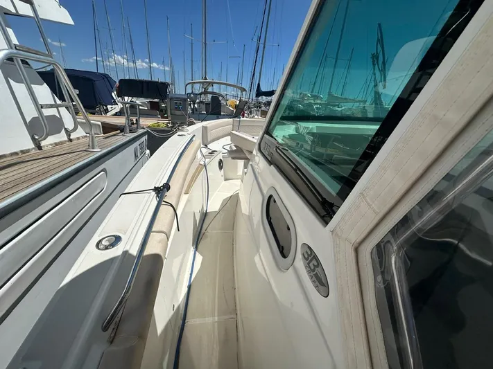  Yacht Photos Pics 2023 3B Craft 330 CC boat docked in a marina under clear blue skies.