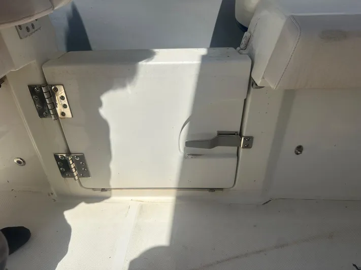 Yacht Photos Pics 2023 3B Craft 330 CC boat interior with white storage compartment and metal hinges.
