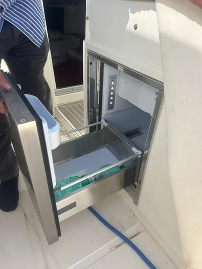  Yacht Photos Pics Open drawer refrigerator on 2023 3B Craft 330 CC boat, showcasing interior storage.