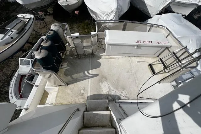 Talisman Yacht Photos Pics 2003 Mainship 430 Aft Cabin Trawler deck with life vests and flares storage.