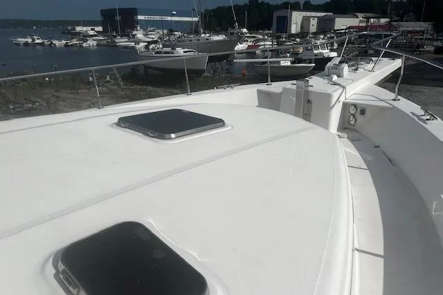 Talisman Yacht Photos Pics 2003 Mainship 430 Aft Cabin Trawler docked at a marina, showcasing its spacious deck.