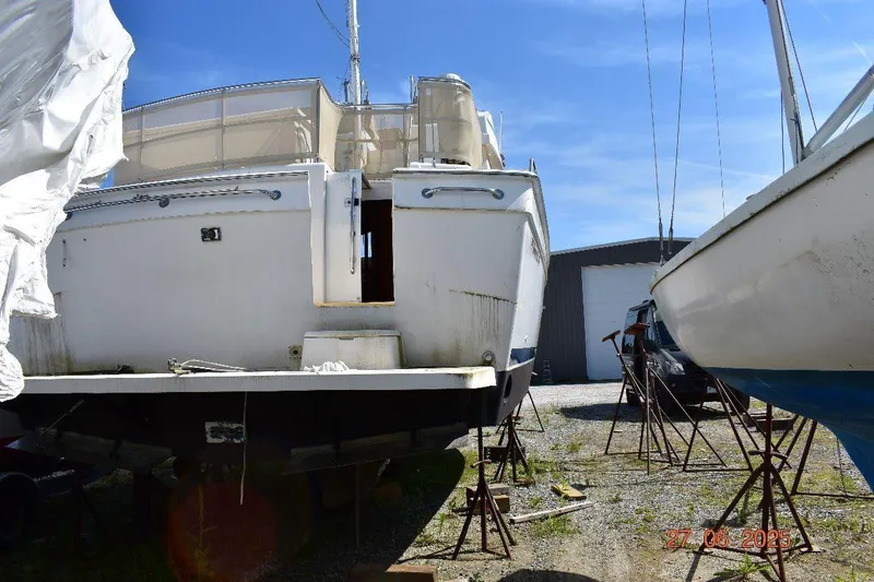 Talisman Yacht Photos Pics 2003 Mainship 430 Aft Cabin Trawler on stands in a boatyard.