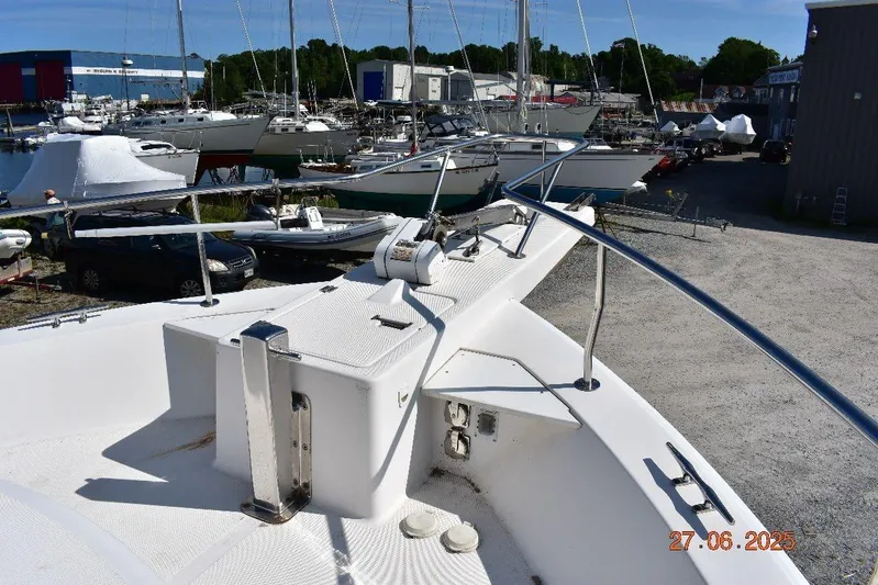 Talisman Yacht Photos Pics 2003 Mainship 430 Aft Cabin Trawler in a marina, surrounded by other boats.