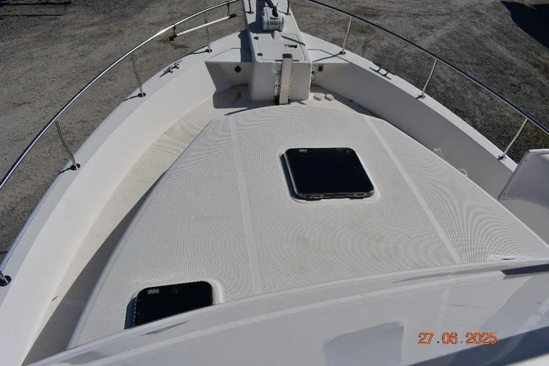 Talisman Yacht Photos Pics 2003 Mainship 430 Aft Cabin Trawler deck view with hatches and railing.