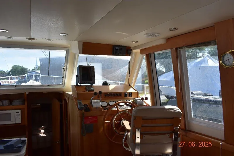 Talisman Yacht Photos Pics Interior of 2003 Mainship 430 Aft Cabin Trawler with helm and navigation equipment.