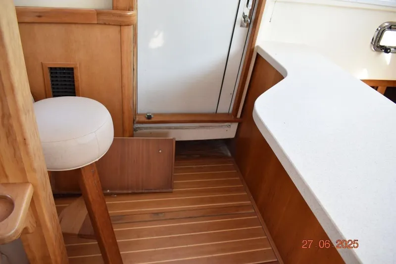 Talisman Yacht Photos Pics 2003 Mainship 430 Aft Cabin Trawler interior with wooden flooring and white countertop.