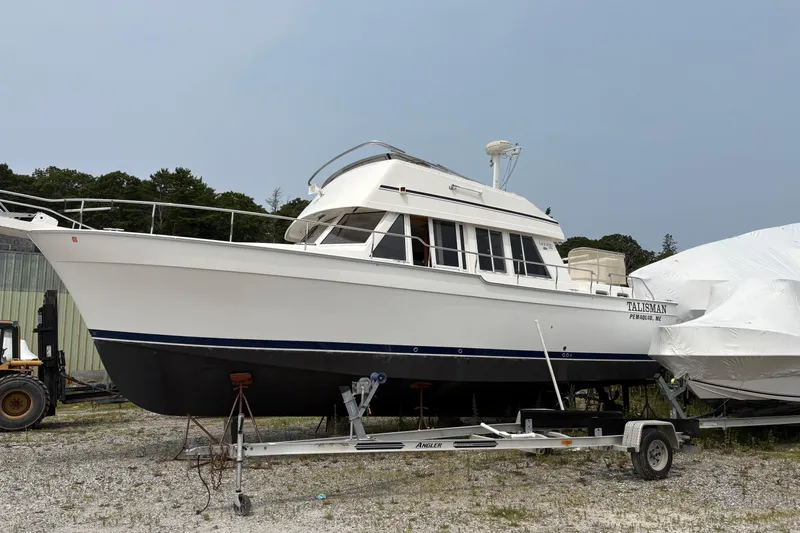 Talisman Yacht Photos Pics 2003 Mainship 430 Aft Cabin Trawler on trailer, outdoor storage setting.