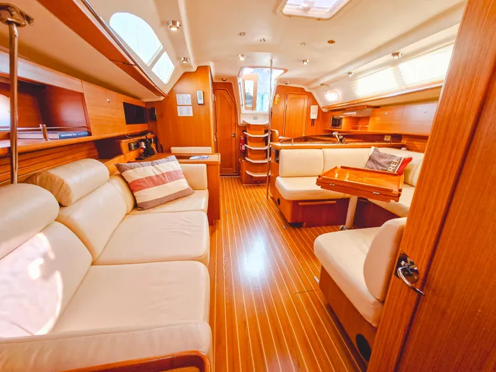  Yacht Photos Pics Luxurious interior of a 2011 Catalina 445 yacht with elegant wood finishes and plush seating.