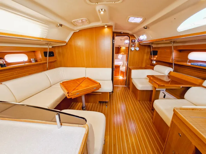 Yacht Photos Pics Spacious interior of 2011 Catalina 445 sailboat with elegant wood finish and comfortable seating.