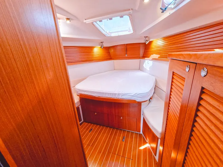 Yacht Photos Pics Luxurious cabin interior of 2011 Catalina 445 sailboat with wood finish and cozy bed.