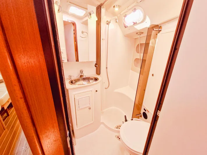  Yacht Photos Pics 2011 Catalina 445 yacht bathroom with sink, shower, and toilet in compact, well-lit space.