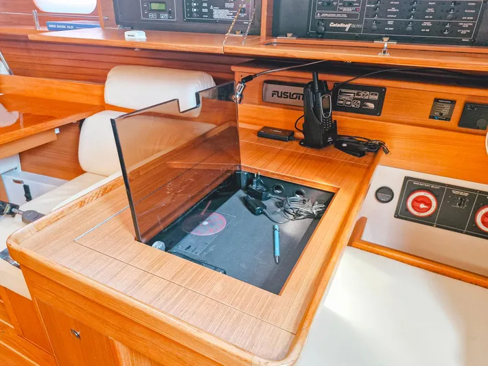  Yacht Photos Pics Interior of 2011 Catalina 445 sailboat with navigation equipment and wooden finish.
