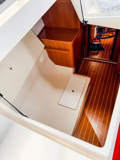  Yacht Photos Pics Interior of 2011 Catalina 445 sailboat with wooden flooring and storage compartment.