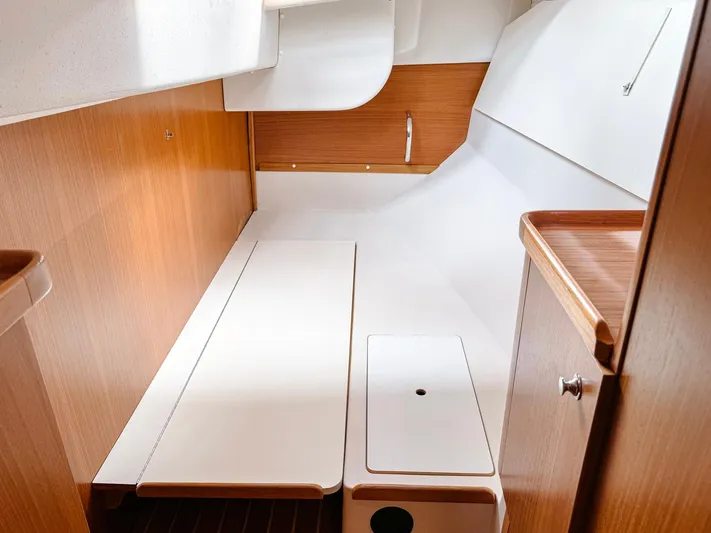  Yacht Photos Pics Interior of 2011 Catalina 445 sailboat, featuring sleek wooden cabinetry and white surfaces.