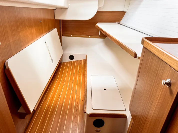  Yacht Photos Pics Interior of 2011 Catalina 445 sailboat with wooden flooring and white cabinetry.