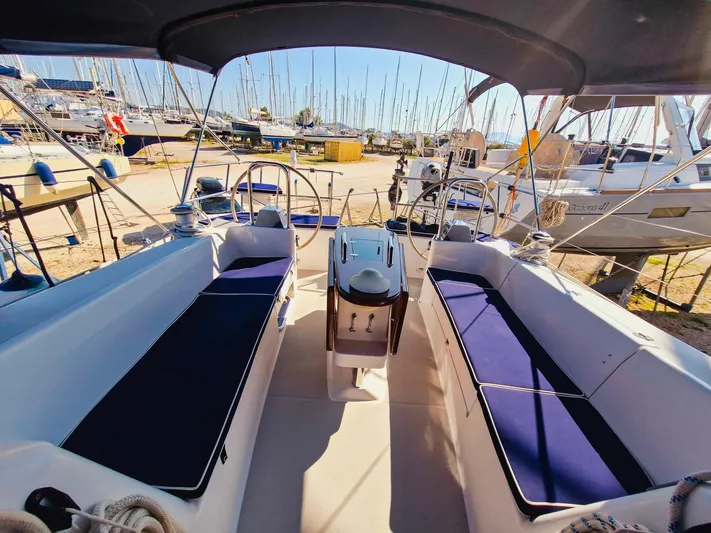  Yacht Photos Pics 2011 Catalina 445 sailboat cockpit with blue cushions, docked in a marina.