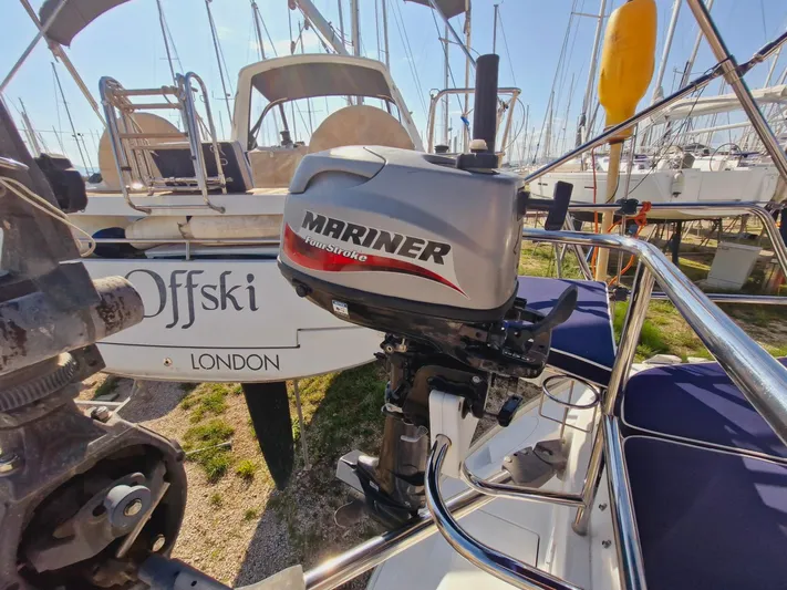  Yacht Photos Pics Catalina 445 sailboat with Mariner outboard motor, docked in a marina, sunny day.