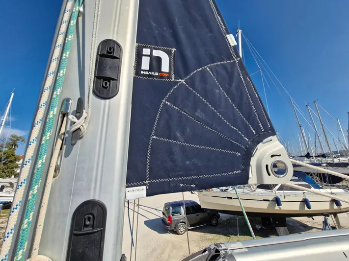  Yacht Photos Pics Sailboat mast and sail detail on a 2011 Catalina 445, with marina background.